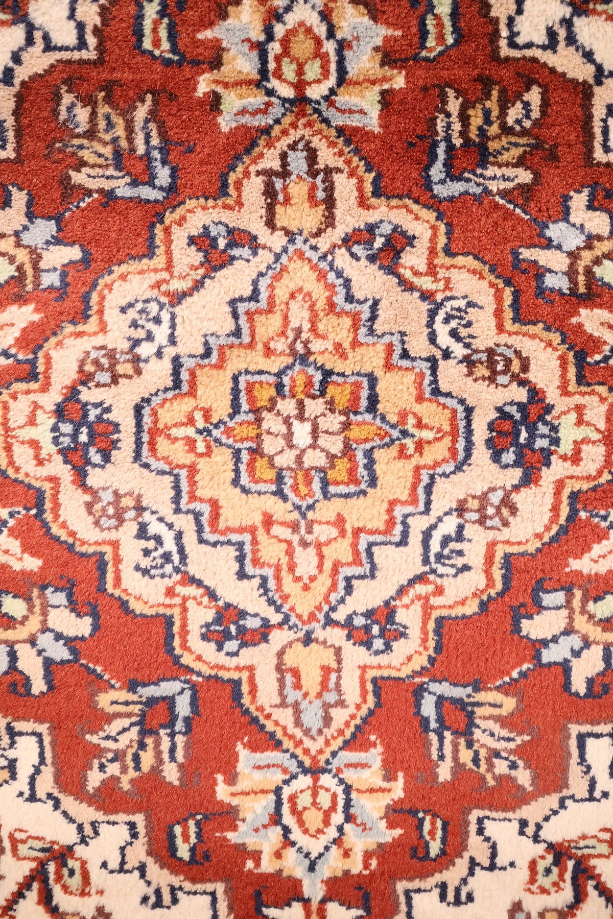 Détail du médaillon en losange rouge à contour denté du tapis Agra