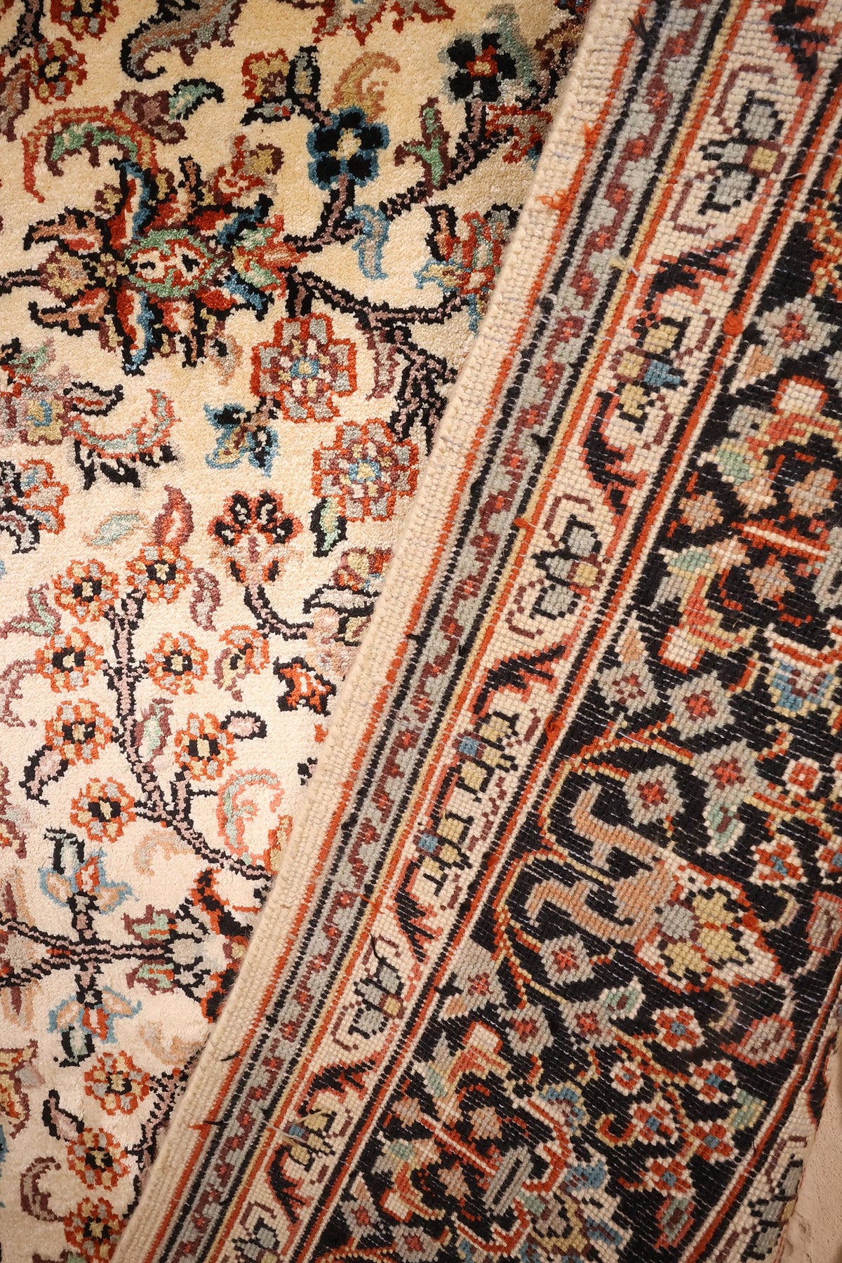Coin replié du tapis Cachemire en soie, champ fleuri et bordure sombre
