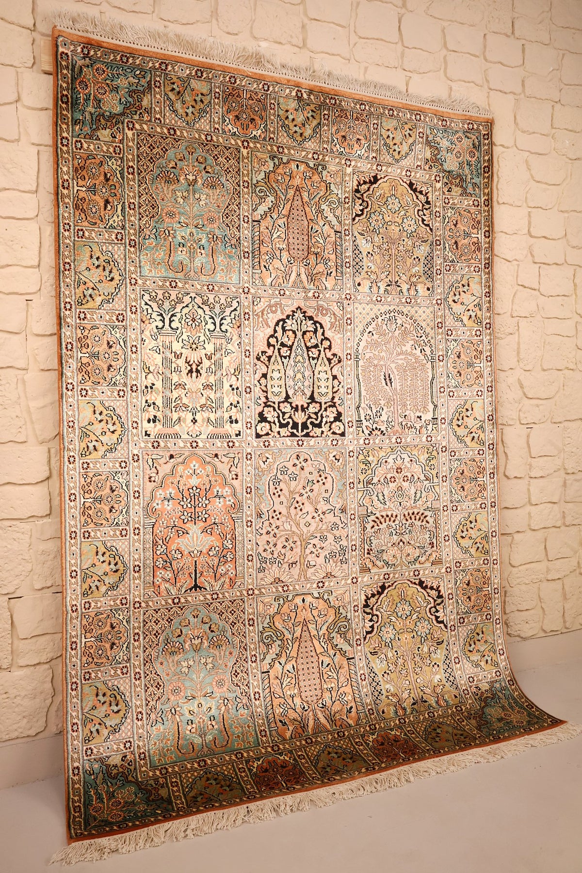 Tapis Cachemire en soie beige et orange, vue de biais avec ses franges claires