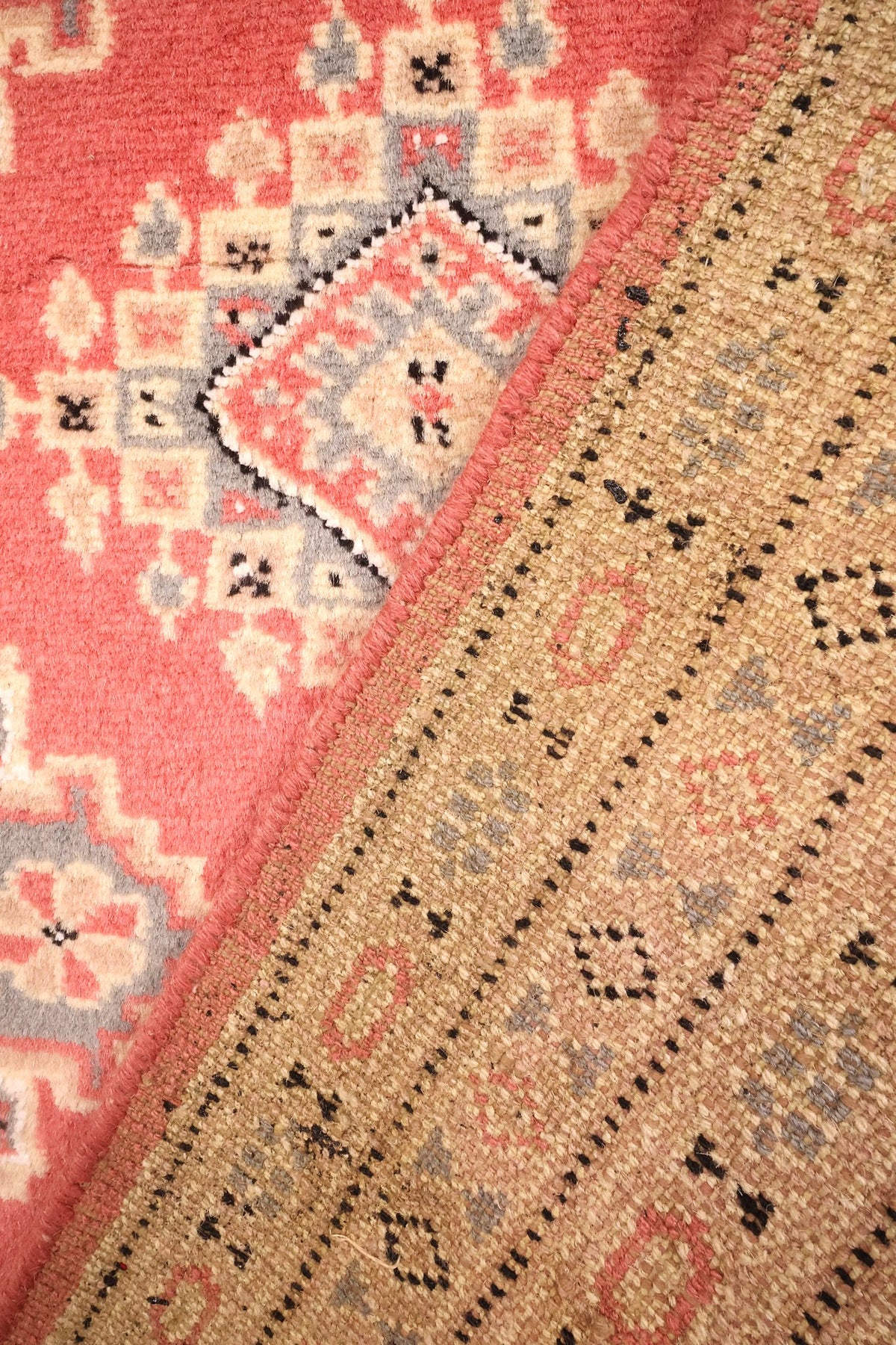 Coin replié du tapis Karachi noué à la main, envers et champ rose côte à côte