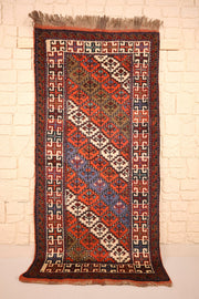 Tapis Pakistan orange 193 × 96 cm, vue d'ensemble du semis de losanges et des franges beiges