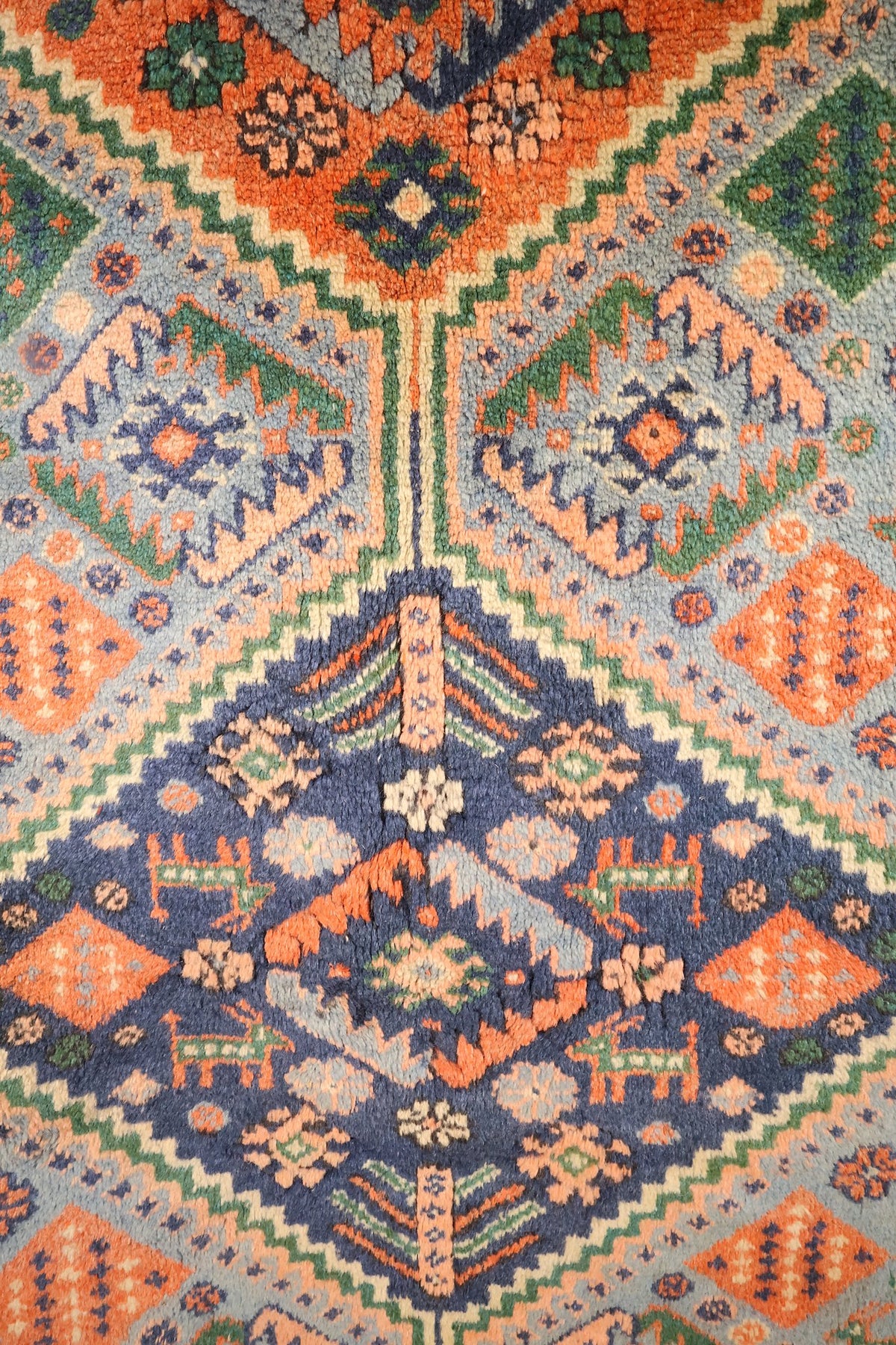 Détail du médaillon bleu foncé et des animaux stylisés du tapis Shirvan