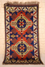 Tapis Tachpinar rouge et bleu 180 × 100 cm à deux médaillons anguleux, vue d'ensemble de face