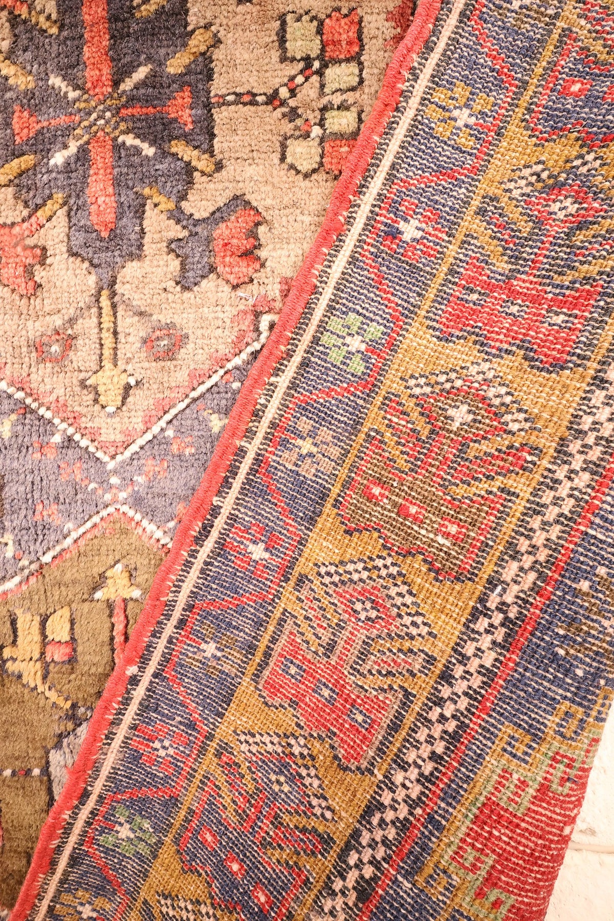 Coin replié du tapis Yahyali 202 × 105 cm, nœuds visibles à l'envers